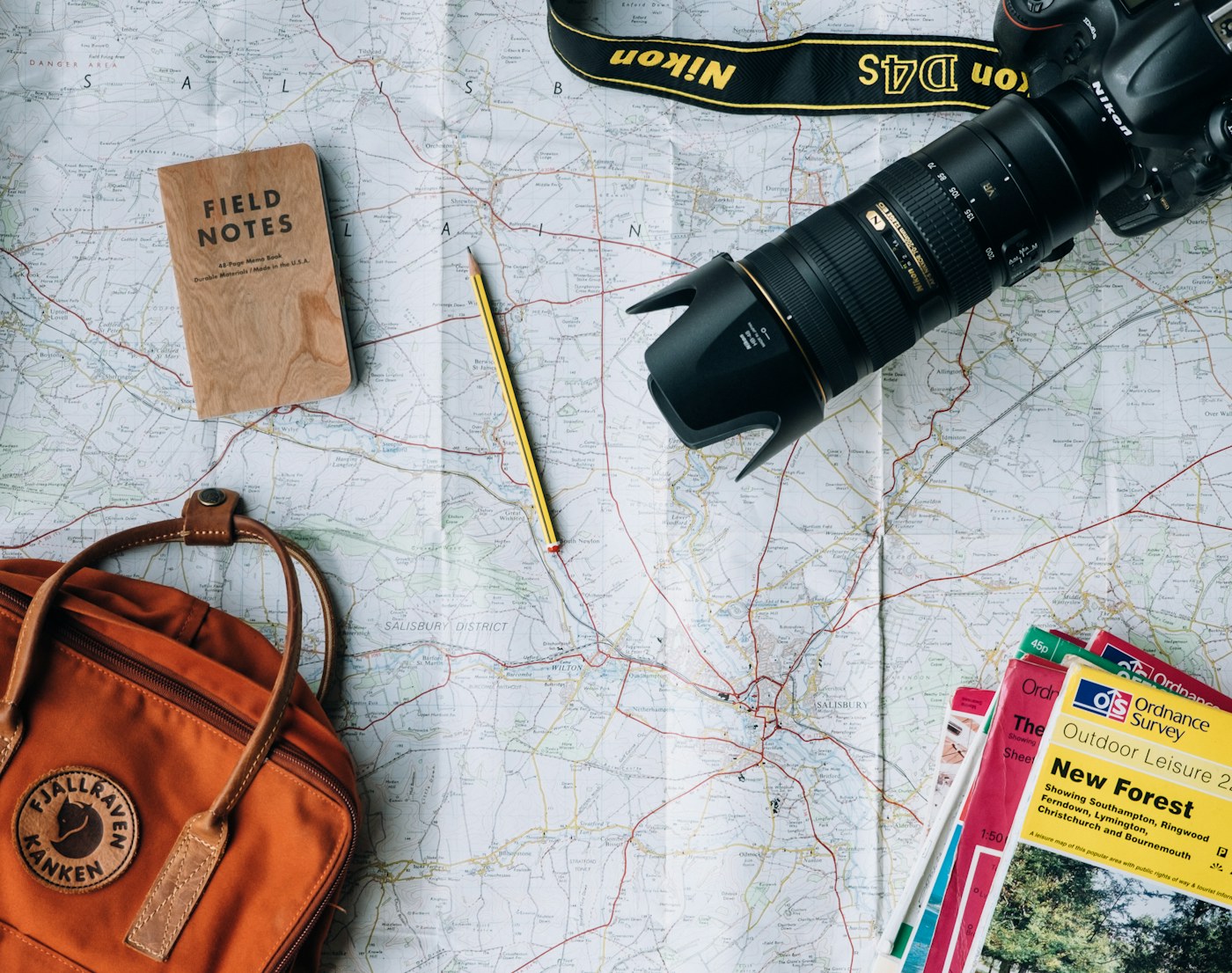 Passport, camera, and travel notes arranged for trip planning